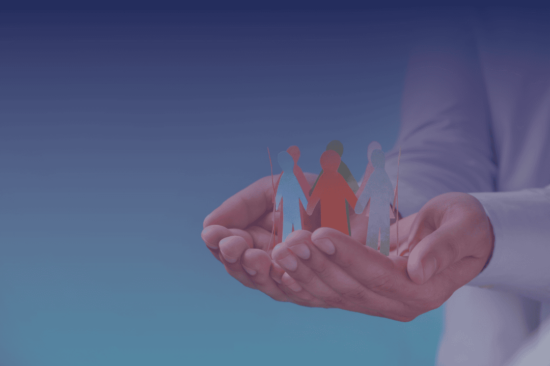 hand holding out paper silhouettes of figures